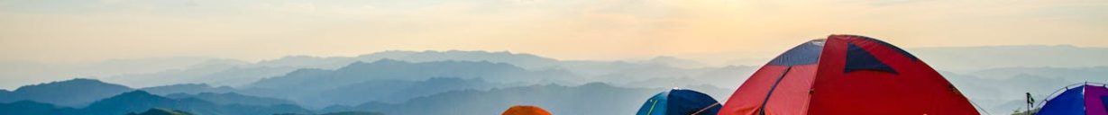 Pitched Dome Tents Overlooking Mountain Ranges camping on top of mountain